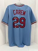 Rear view showing red CAREW name and 29 with white autograph and HOF 91 inscription on powder blue mesh jersey