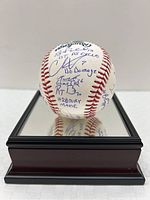 Baseball on a mirrored display stand showing overall set of signatures
