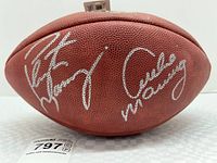 Full view of brown leather football showing both signatures