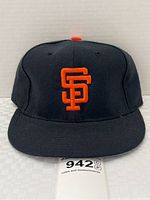 Front view of black San Francisco Giants hat with orange embroidered SF logo