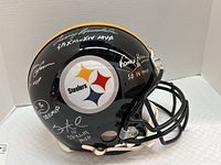 Right side view of black full-size Steelers helmet with multiple silver signatures