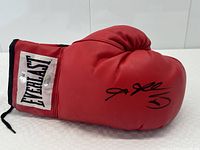 Side view of red Everlast boxing glove showing signature and logo patch