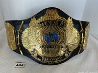 Front view of the replica belt showing center plate and signature