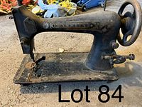 Side view of antique Franklin sewing machine showing worn black paint, floral gold detailing, brand name on arm, missing parts on base and around needle area