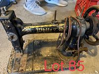 Side view of Black White brand sewing machine with decorative gold designs and rust on metal parts.