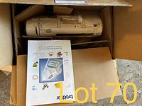 Brother DC3050 sewing machine still in box with manual/ booklet visible.