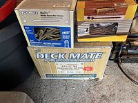 Boxes of Deckmate deck screws, sizes and branding visible