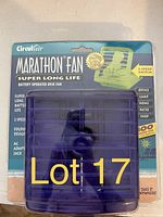 Photo of packaged Marathon Fan Super Long Life battery operated purple desk fan with 2 speed switch and AC adapter jack