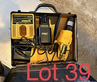 Yellow DeWalt corded drill inside an open box with battery and charger.