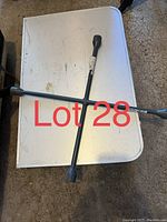 Cross lug nut wrench shown from top view on white surface with four different sized sockets visible.