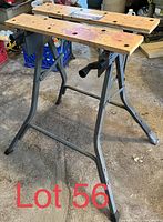 Full view of the Black & Decker Workmate portable workbench with metal frame and wooden plank tops.