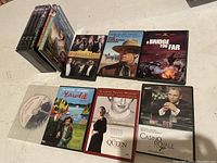 DVD lot with 11 DVDs including Downton Abbey seasons, The Moon Is Blue, A Bridge Too Far, Maudie, The Queen, Casino Royale 007, and one loose DVD disc.