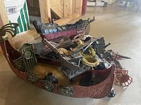 Photo of multiple pirate ship play sets stacked together showing hull details, pirate figures, and accessories.