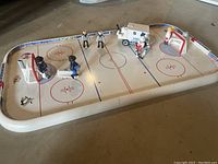 Full view of Playmobil hockey rink with players and Zamboni on ice