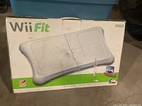 Original boxed Wii Fit balance board showing some dirt and wear on the box