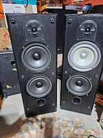 Front view of the pair of Bowers and Wilkins VR 203 black speakers showing drivers.
