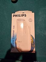 Box front showing Philips Garment Steamer TS185 model and branding.