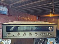 Front view of Pioneer Sound Project Model 300 receiver showing silver face with black tuning window, large function and tuning knobs, and smaller control knobs.