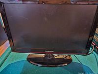 Front view of the Samsung 22-inch TV showing the screen with a visible thin scratch line near top left.