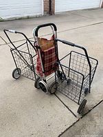 Photo showing two wire frame buggies and one fabric buggy together outside on concrete.