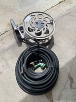Full lot with garden hose wound and hose reel with mounting bracket visible
