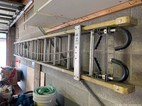 Full length view of the 12-foot extendable ladder showing aluminum rungs and yellow fiberglass rails.