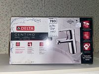 Front view of the sealed box showing the brand, model name Centimo, and faucet image.