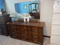 Full view of the wooden Bassett dresser with mirror, showing the wave front for the drawer fronts and condition of the surface
