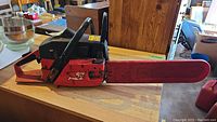 Left side view of the Jonsered 625 chainsaw showing the entire cutting bar and most of the body with brand and model logos.