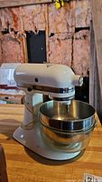 Side view of KitchenAid stand mixer showing overall condition and attached mixing bowl.