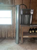 Overview showing both the cylindrical stovepipe section and the rectangular baffle pan