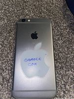 Apple iPhone phone shown from back with Apple logo and sticker 'Carole Cox'