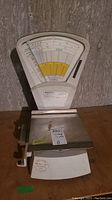 Full view of vintage postal scale showing dial, platform, and base.