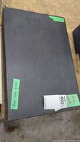 Top view of black granite table top with tags