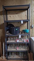 Front view of metal framed shelving with items on shelves (not included). Shows size and layout of shelves.
