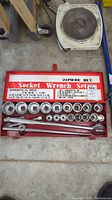 Complete 21 piece socket wrench set in red metal case showing all sockets, ratchets, and handles