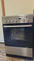 Front view showing stainless steel control panel, door and base