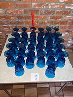 Overhead group shot of 36 cobalt blue goblets on table