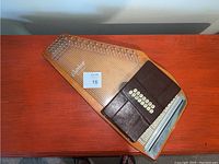 Full top-down view of the Oscar Schmidt auto harp showing the entire wooden frame, strings, and chord button area covered in brown material.