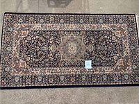 Full view of a 60" Turkish rug showing the intricate floral and medallion pattern in navy and cream colors.