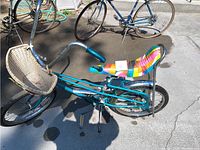 Side view of teal blue girl's child's bicycle showing banana seat and frame.
