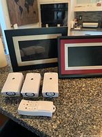 Two digital photo frames and three flameless candle units with remote