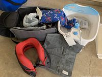 All items including plastic foot soaker basin with blue top, heatable magic bag, red neck pillow, and nebulizer mask with tubing.