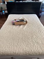 Full front view of dark espresso platform bed frame with mattress and fleece cover