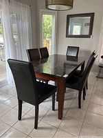 Full set showing rectangular table with stone top and six chairs in room