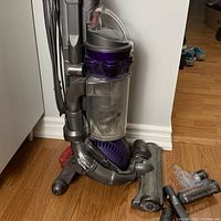 Full upright vacuum with ball base next to motorized head and mini turbine accessory