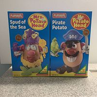 Front boxed view of factory sealed PlaySkool Mr. and Mrs. Potato Head figurines: Spud of the Sea (Mrs.) and Pirate Potato (Mr.)