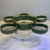 Full view of the large serving bowl with five smaller hanging bowls all supported within a metal frame.
