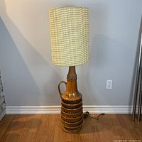 Full front view of lamp showing base, neck, shade and cord