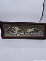 Full view of the framed picture showing the entire woman reclining on the tiger hide within a wooden frame.